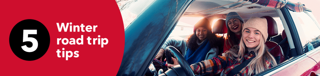 women in a car wearing winter hats on a road trip